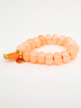 Elastique coloré et perles donuts colorées (10 coloris)